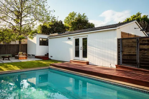 a swimming pool with outdoor seating and yard