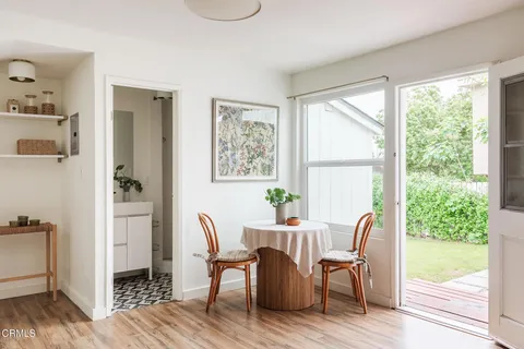a view of a dining room with furniture and windows