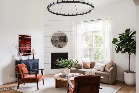 a living room with furniture a window and a fireplace