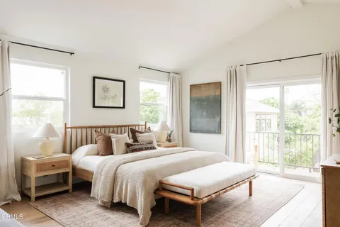 a bedroom with a bed and a large window