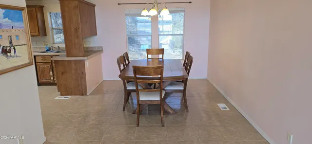 a dining room with furniture and window