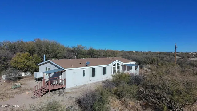 an aerial view of a house with a big yard