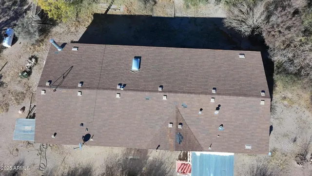 an aerial view of house with a yard