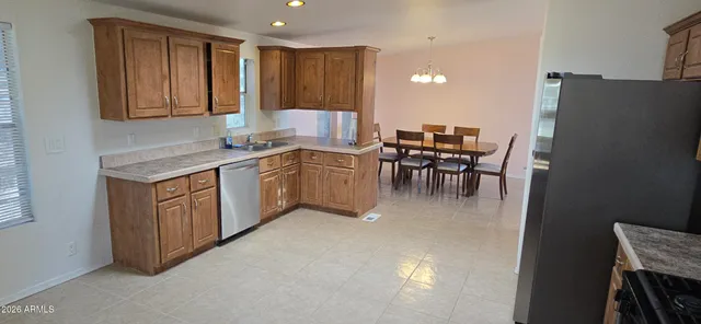 a kitchen with a table chairs and a refrigerator