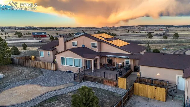 a view of a chairs and table in the balcony