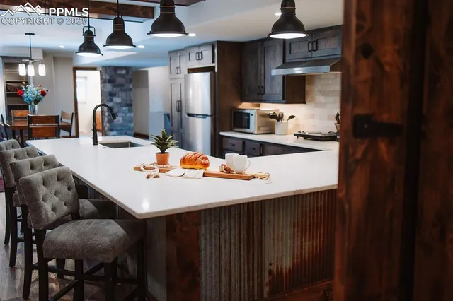 a living room with lots of furniture and kitchen view