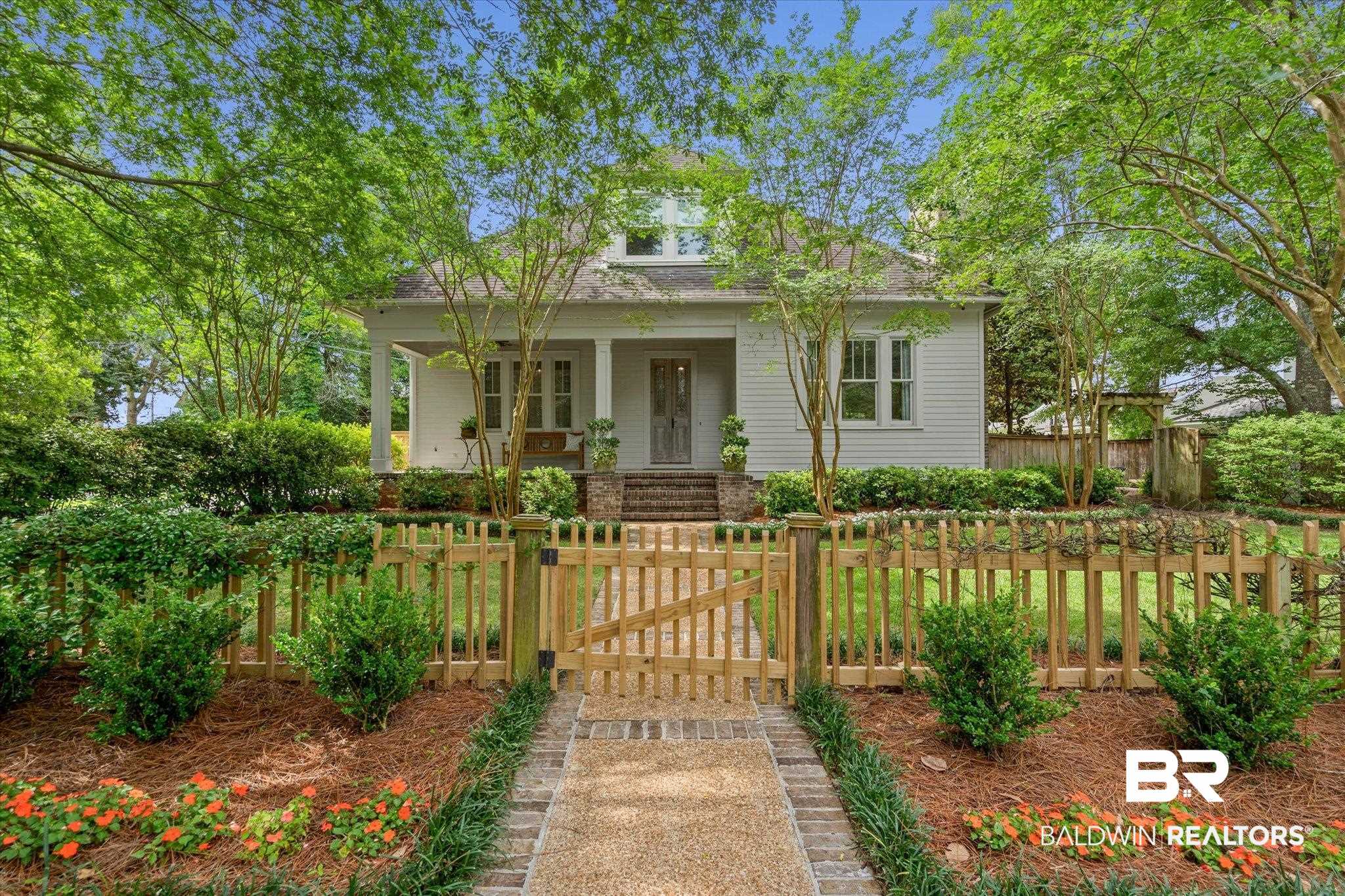 3813 Austill Lane Mobile, AL 36608 - Photo 1 of 37 White clapboard siding exterior with a covered front porch featuring brick columns
