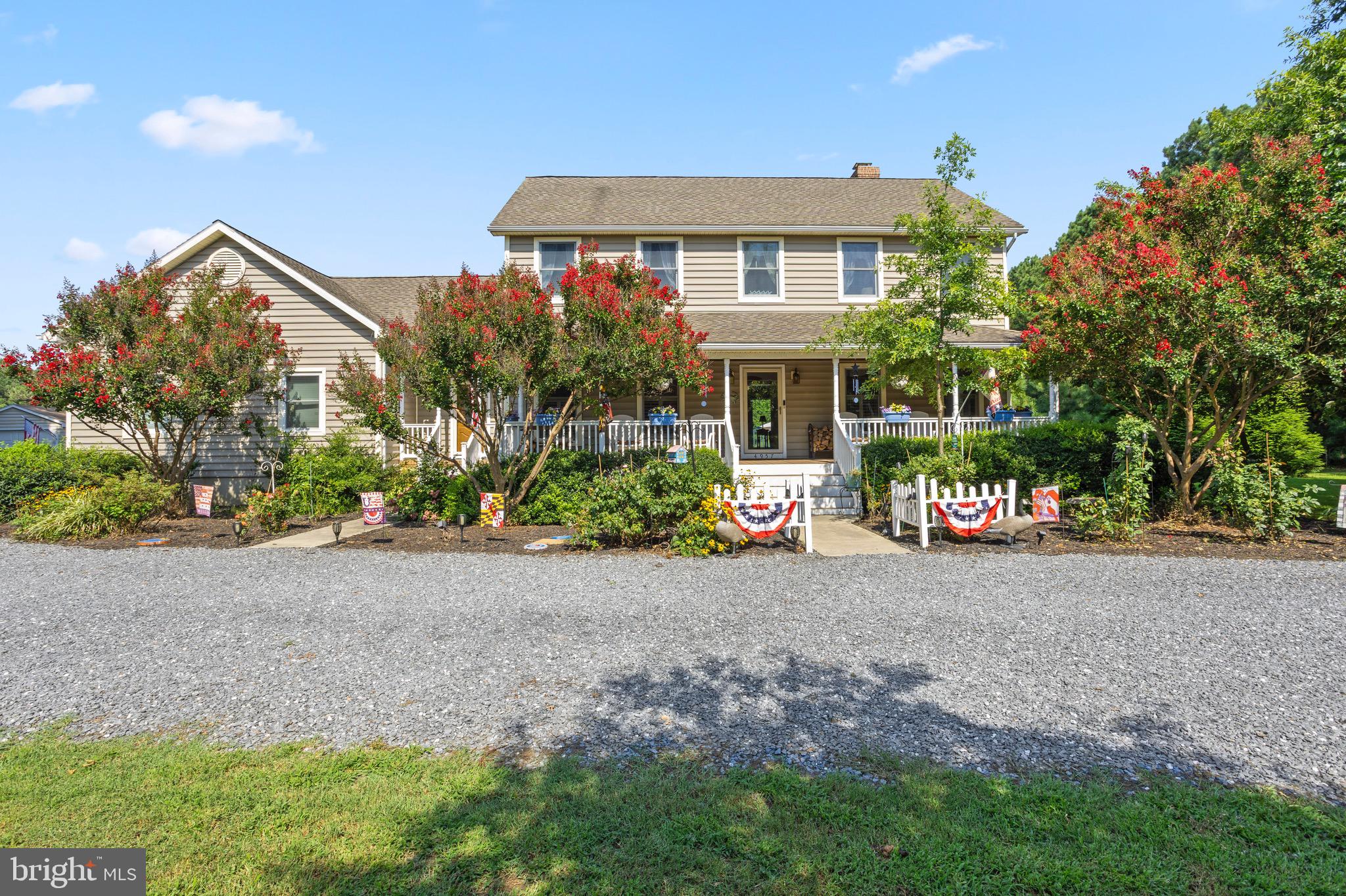 4957 Bar Neck Road Tilghman, MD 21671 - Photo 1 of 45 a front view of a house with a yard and a garage