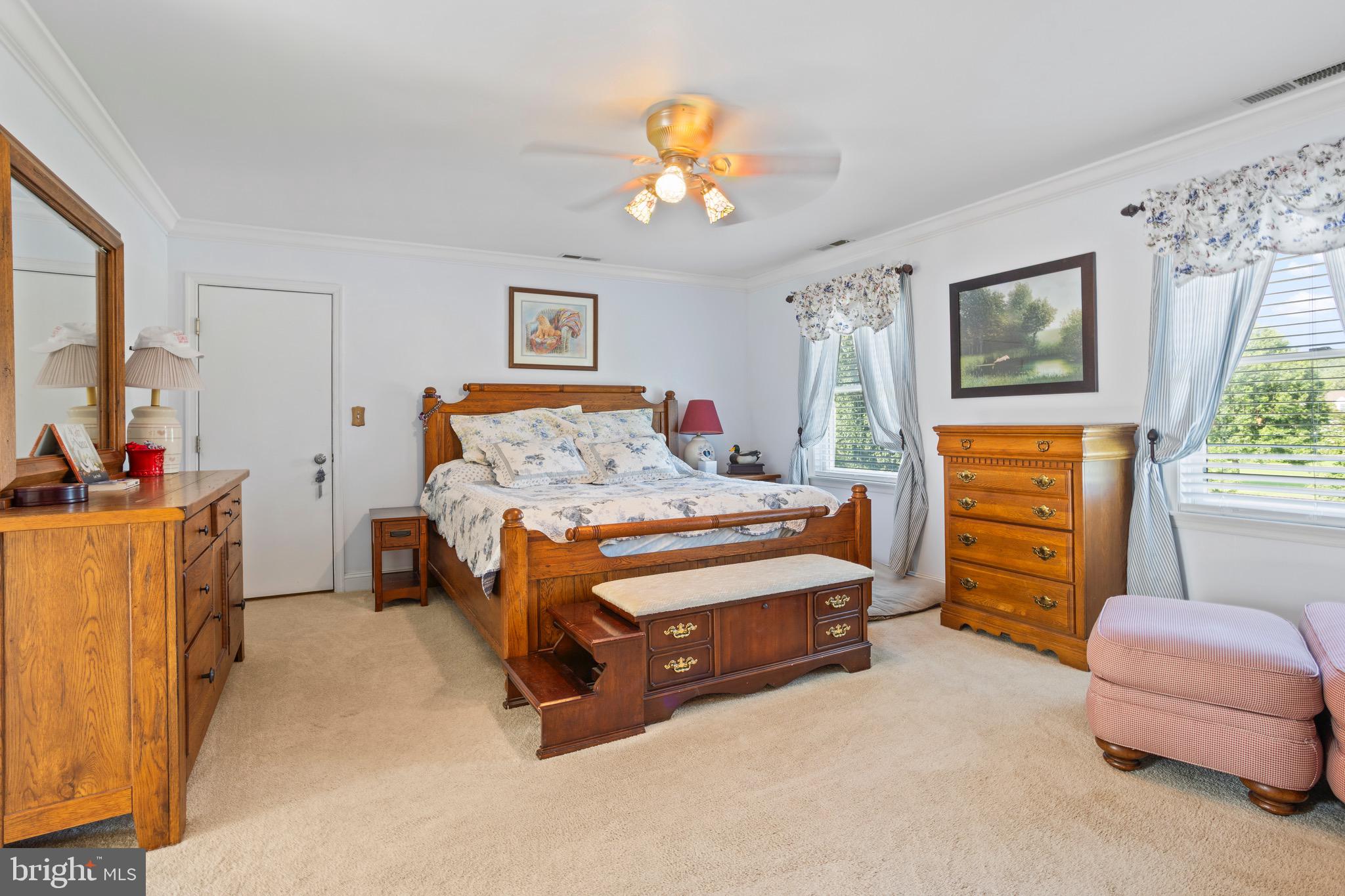 4957 Bar Neck Road Tilghman, MD 21671 - Photo 29 of 45 a bedroom with a bed and a chandelier