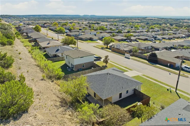 a view of a backyard with a garden and deck