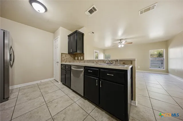 a kitchen with stainless steel appliances a stove microwave and cabinets