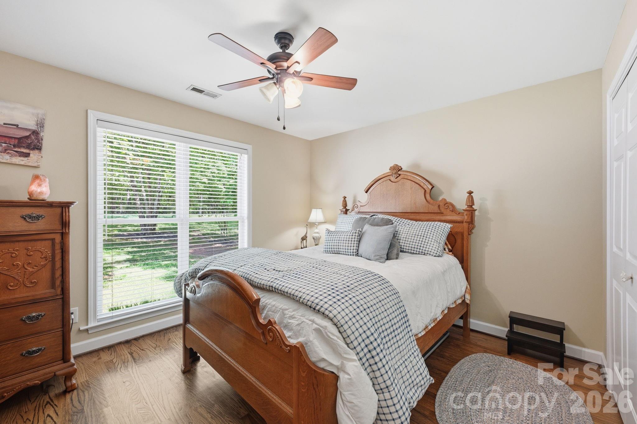 145 Upper Spencer Mountain Road Stanley, NC 28164 - Photo 23 of 29 a bedroom with a bed a window and a chandelier