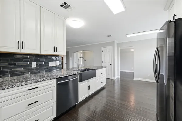 a kitchen with stainless steel appliances granite countertop a refrigerator and a sink