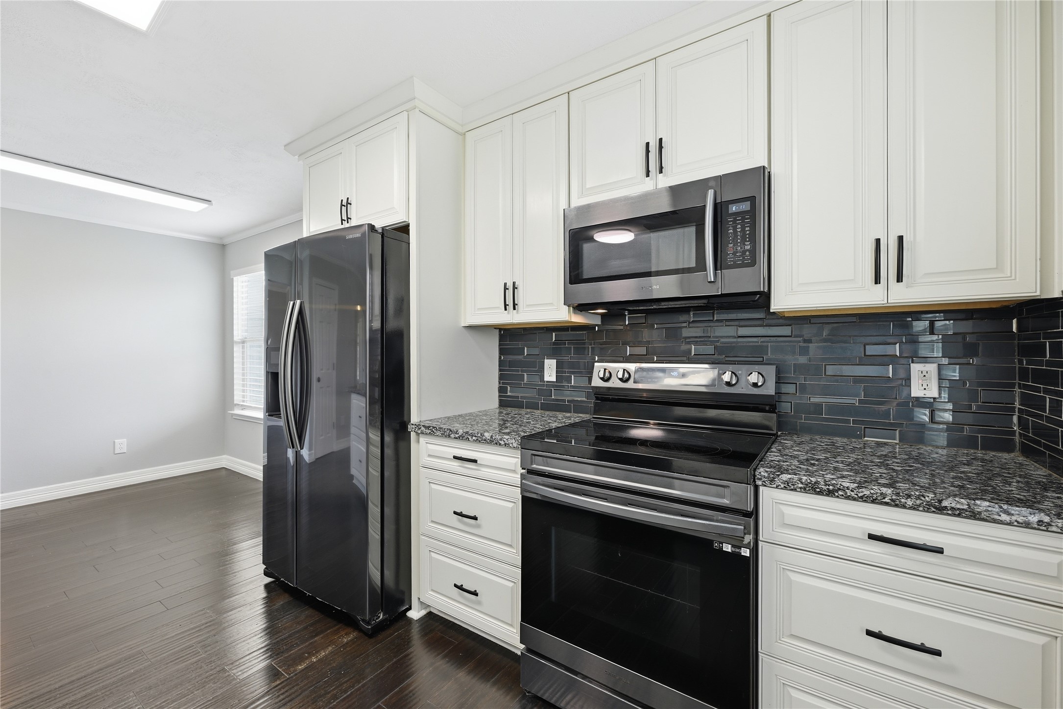 7218 Kransburg Ranch Drive Cypress, TX 77433 - Photo 12 of 27 a kitchen with stainless steel appliances granite countertop a stove a refrigerator and a microwave