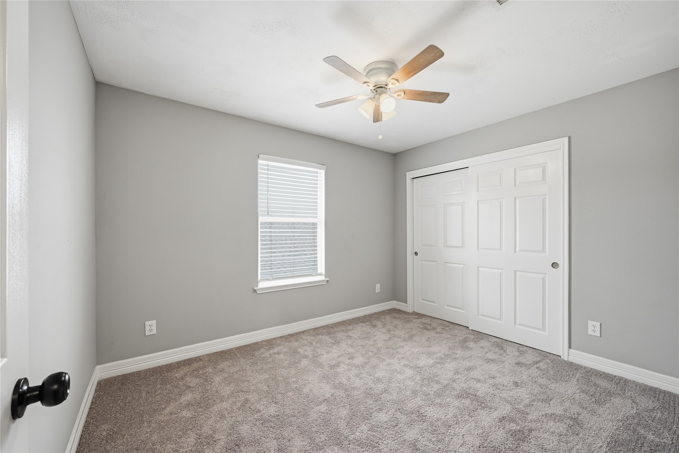 7218 Kransburg Ranch Drive Cypress, TX 77433 - Photo 24 of 27 an empty room with windows and fan
