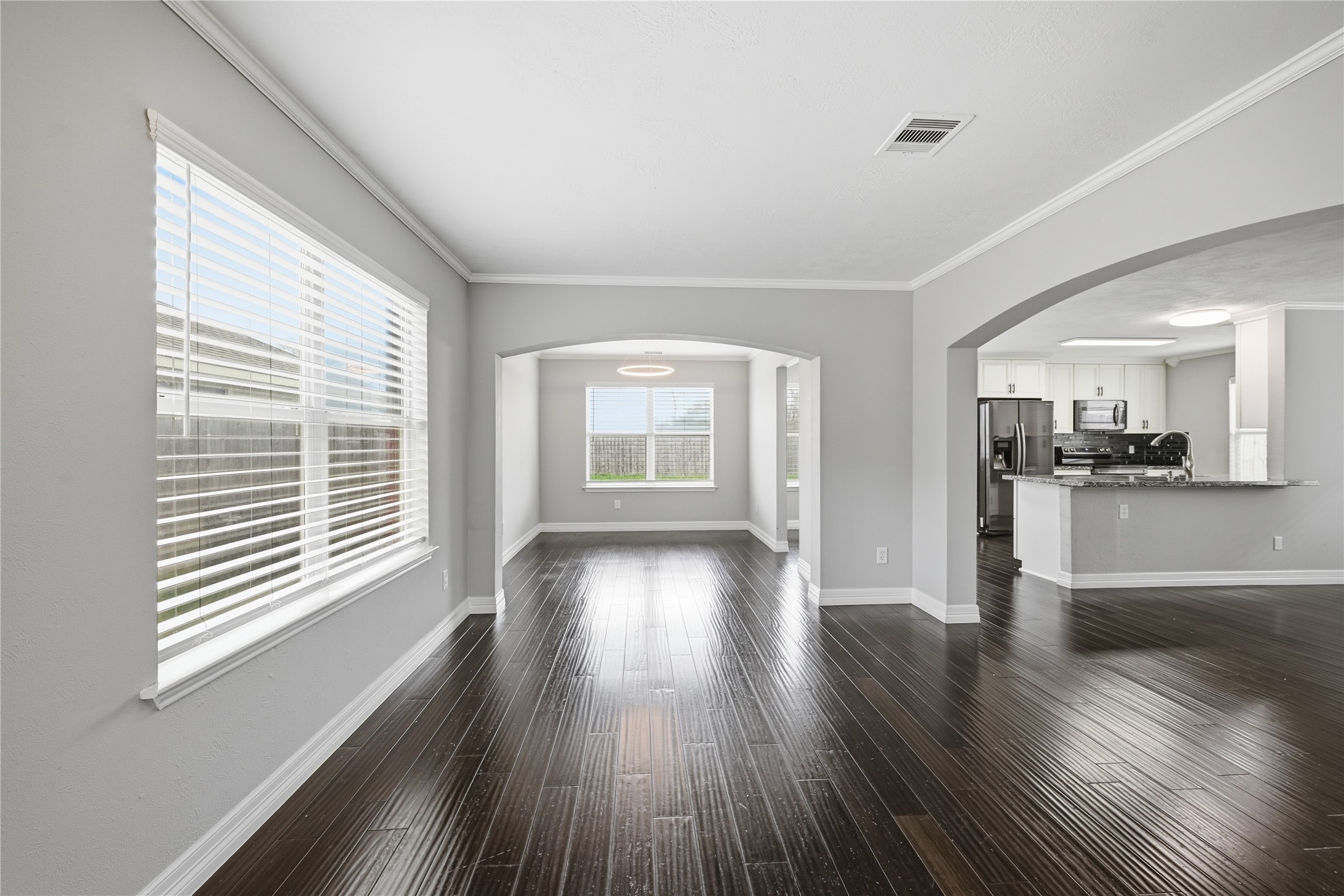 7218 Kransburg Ranch Drive Cypress, TX 77433 - Photo 6 of 27 a view of an empty room with wooden floor and a window