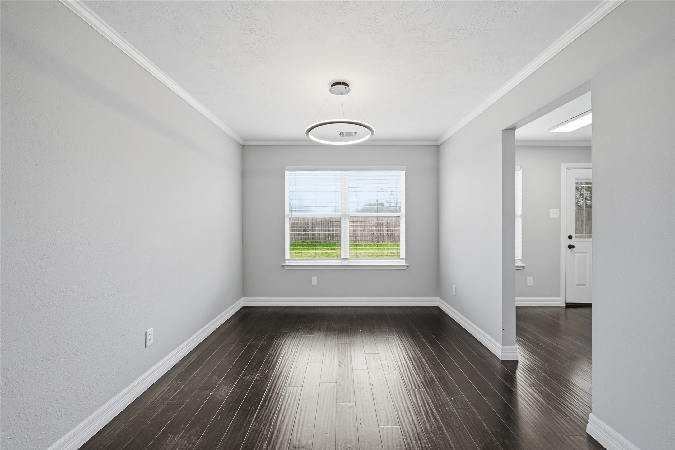 7218 Kransburg Ranch Drive Cypress, TX 77433 - Photo 7 of 27 an empty room with wooden floor and windows