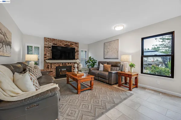 a living room with fireplace furniture and a flat screen tv