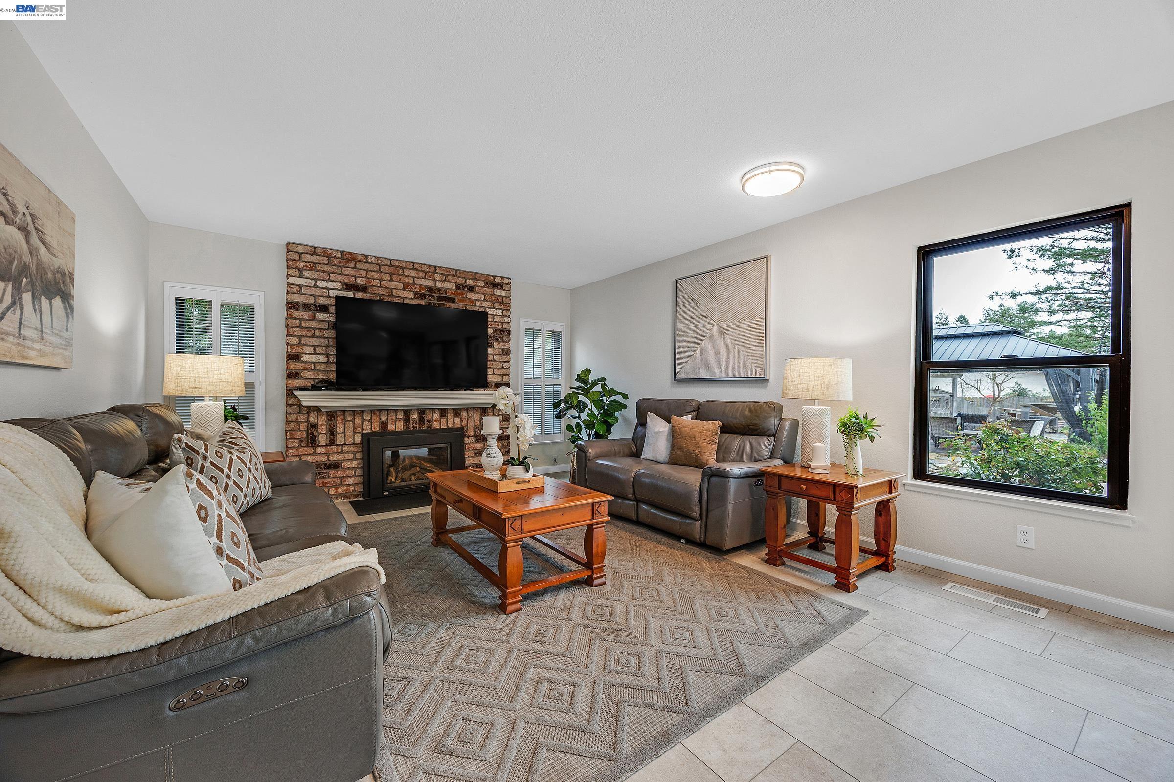 a living room with fireplace furniture and a flat screen tv