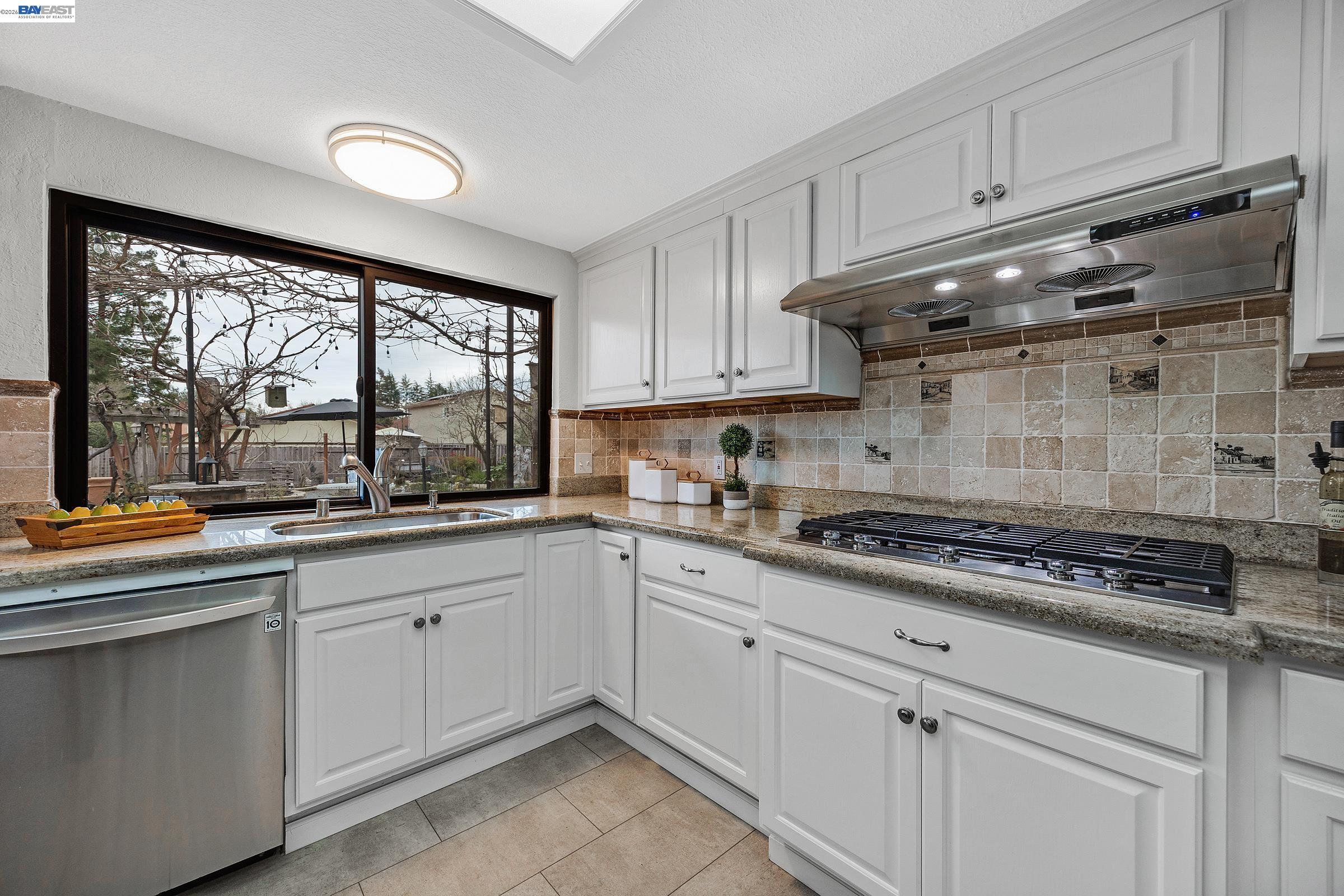 3020 Ascot Drive San Ramon, CA 94583 - Photo 14 of 45 a kitchen with granite countertop white cabinets and white appliances