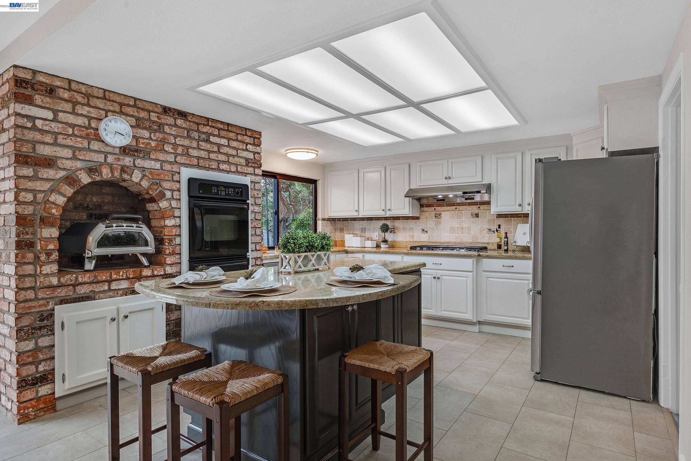 3020 Ascot Drive San Ramon, CA 94583 - Photo 16 of 45 a kitchen with a sink a refrigerator and chairs