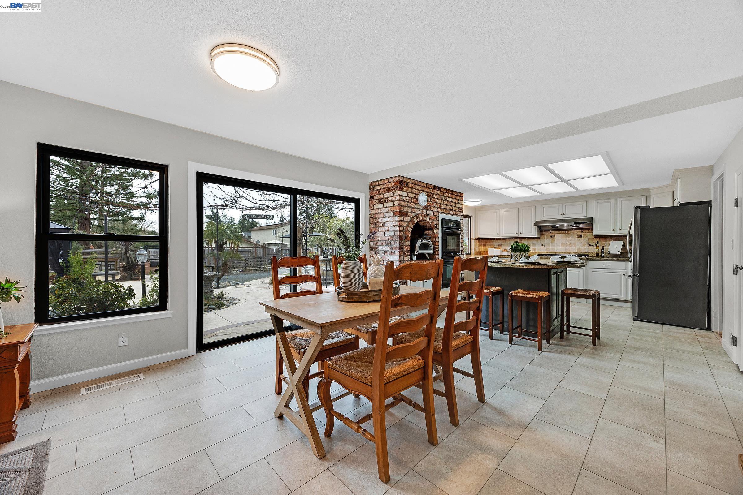3020 Ascot Drive San Ramon, CA 94583 - Photo 18 of 45 a dining room with furniture and a floor to ceiling window
