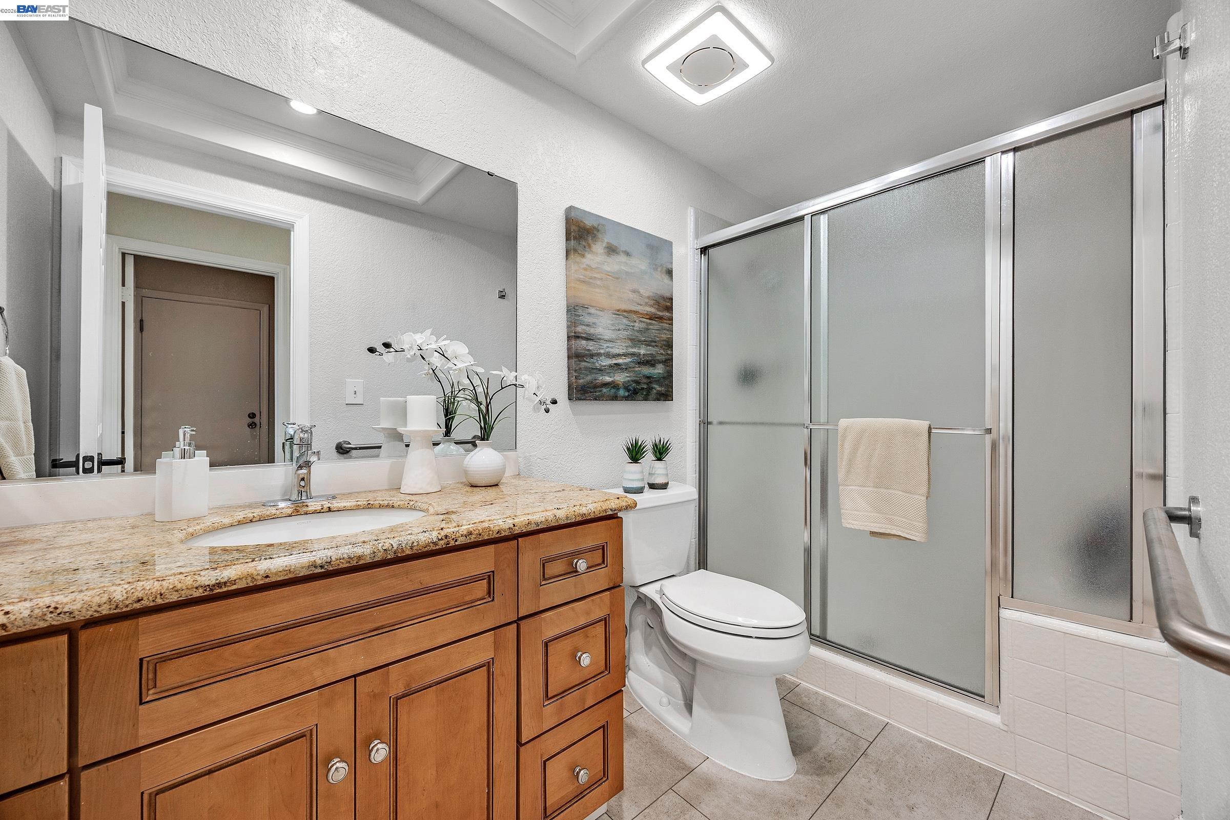 3020 Ascot Drive San Ramon, CA 94583 - Photo 22 of 45 a bathroom with a granite countertop sink toilet and shower