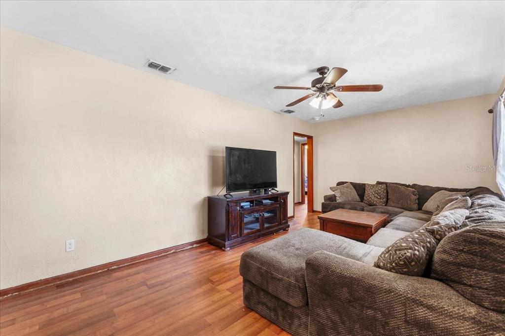 113 4th Street Winter Haven, FL 33880 - Photo 9 of 35 a living room with furniture and a flat screen tv