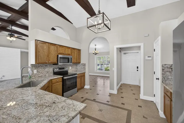 a kitchen with a sink stove and microwave