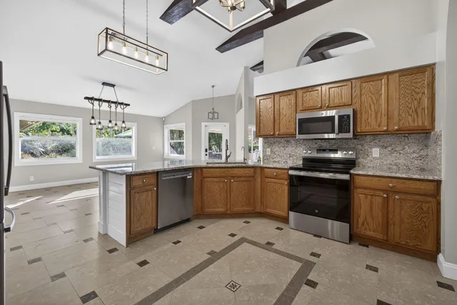 a kitchen with a refrigerator sink and stove