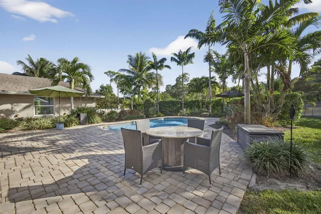 a view of a house with a yard and a garage