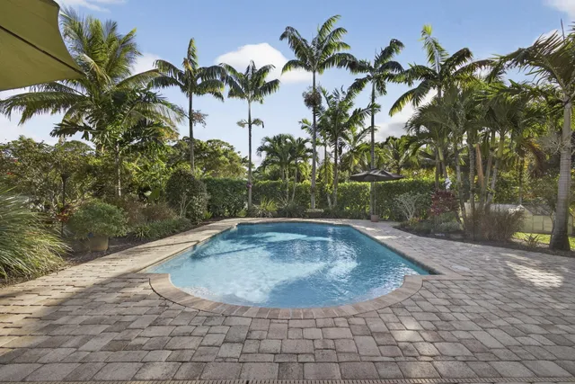 a view of a house with a yard and a garden