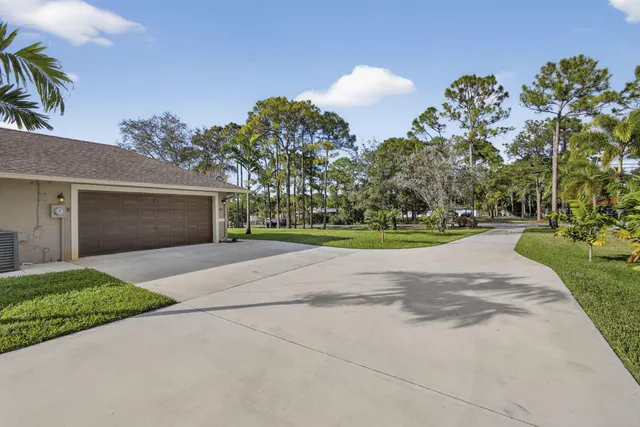 a view of a house with yard and a garden