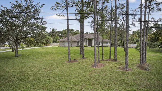 an aerial view of a house with a yard basket ball court and outdoor seating