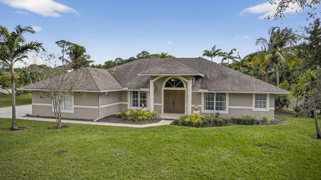 an aerial view of residential houses with outdoor space and swimming pool