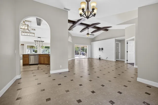 a spacious bathroom with a granite countertop sink a mirror and shower