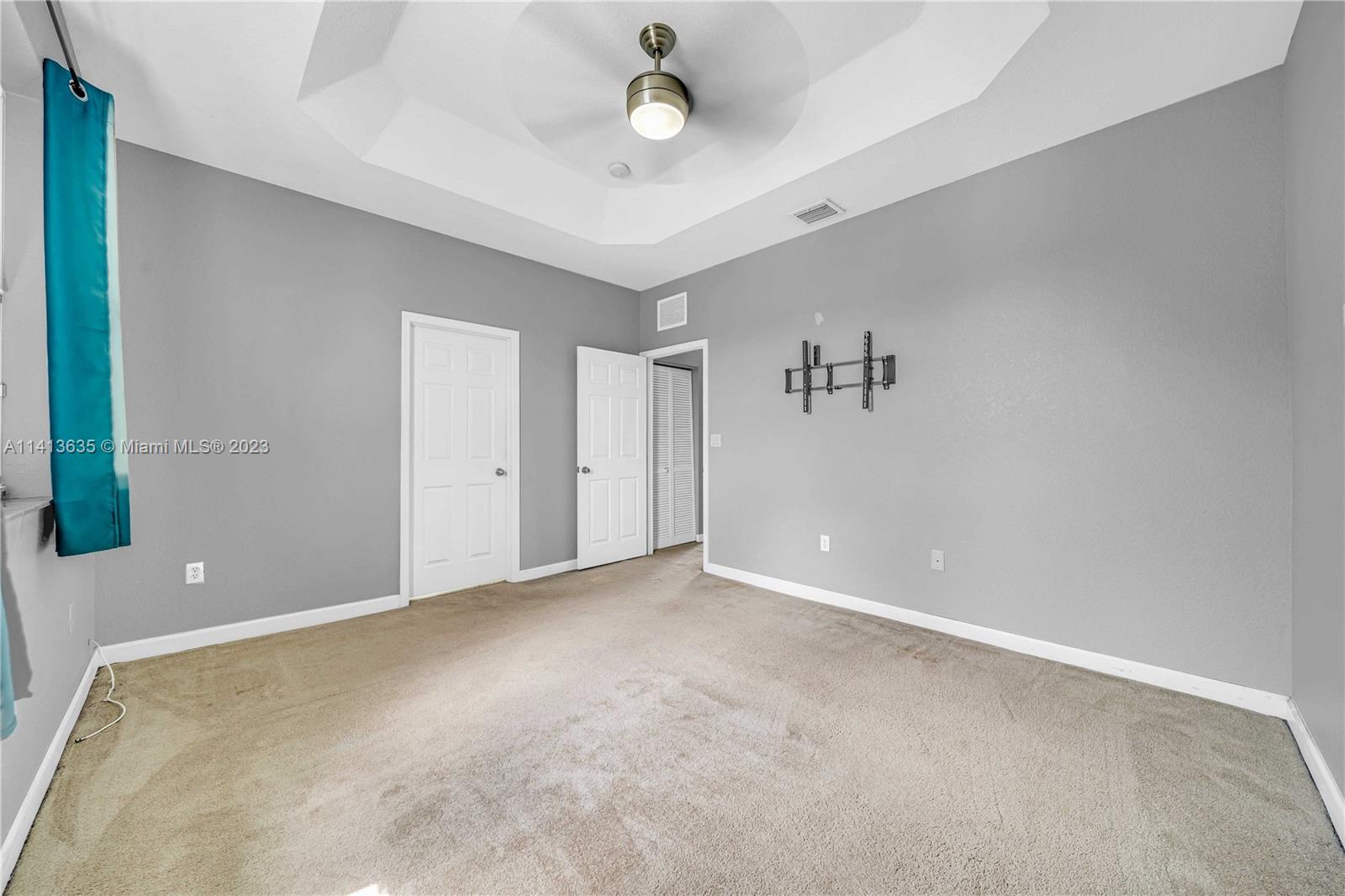 949 Northeast 42nd Avenue Homestead, FL 33033 - Photo 15 of 22 an empty room with fan and windows