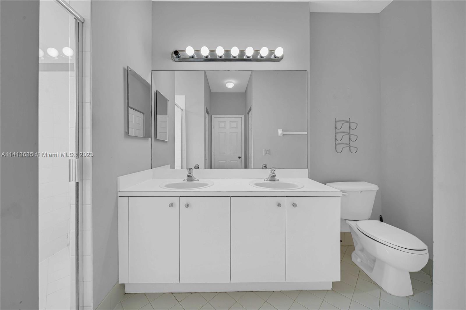 949 Northeast 42nd Avenue Homestead, FL 33033 - Photo 17 of 22 a bathroom with a toilet a sink and a mirror