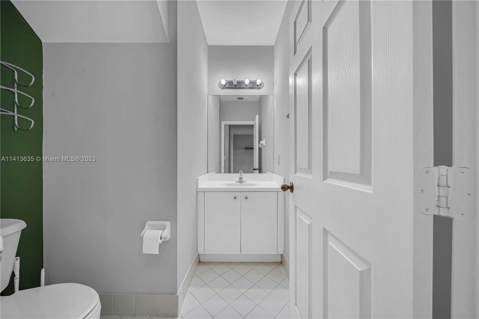 949 Northeast 42nd Avenue Homestead, FL 33033 - Photo 5 of 22 a bathroom with a sink a toilet and mirror