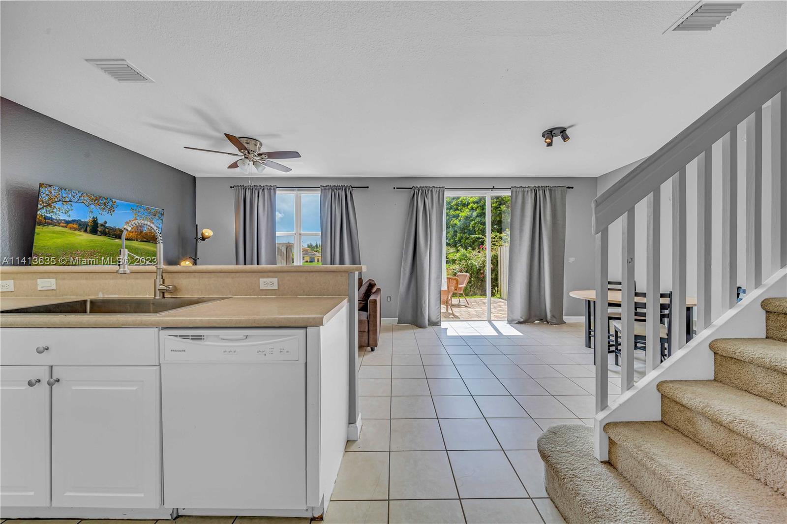 949 Northeast 42nd Avenue Homestead, FL 33033 - Photo 8 of 22 a kitchen with stainless steel appliances granite countertop a sink and a refrigerator