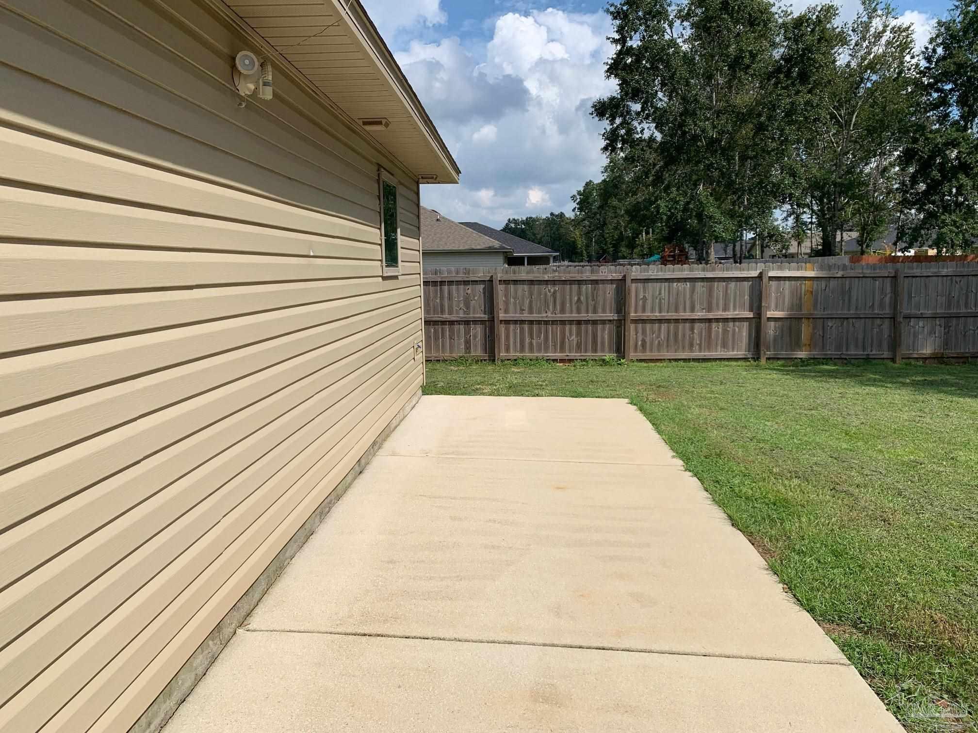 5685 Peach Drive Pace, FL 32571 - Photo 16 of 16 a view of backyard with wooden fence
