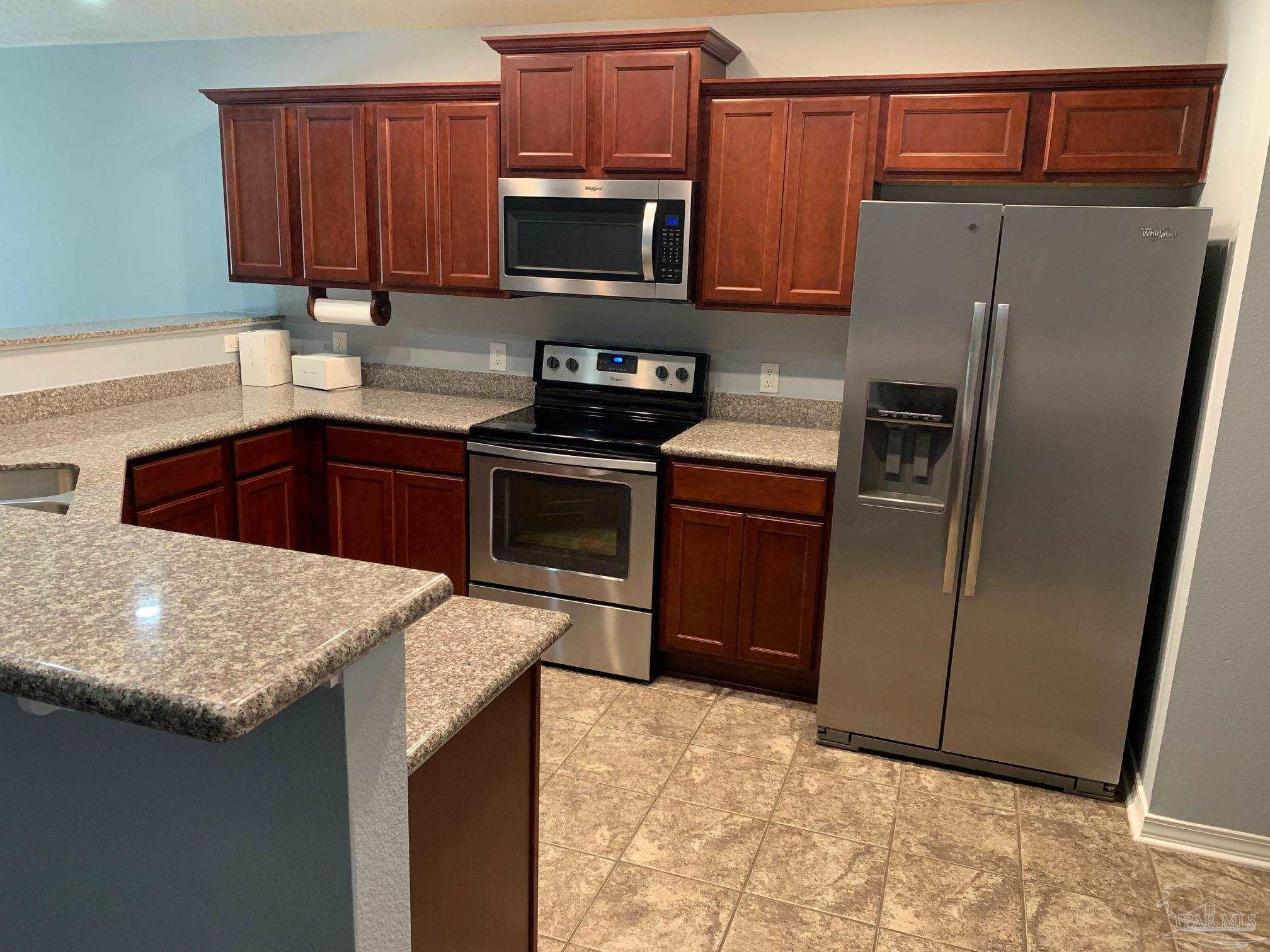 5685 Peach Drive Pace, FL 32571 - Photo 4 of 16 a kitchen with a refrigerator sink and microwave