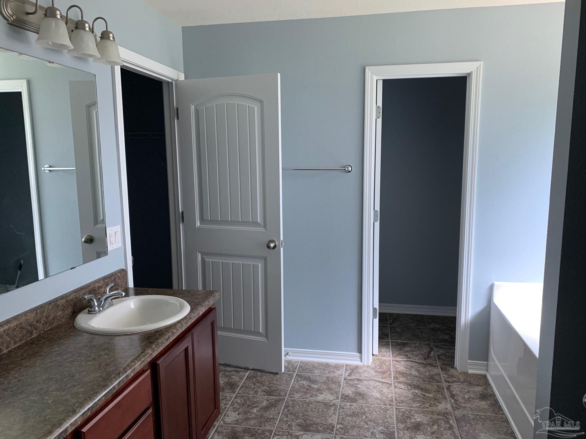 5685 Peach Drive Pace, FL 32571 - Photo 6 of 16 a bathroom with a sink and a mirror