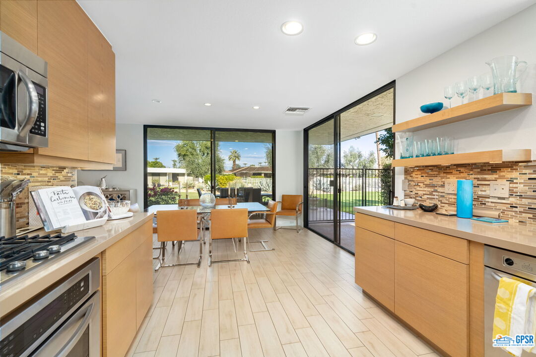 78 Colgate Drive Rancho Mirage, CA 92270 - Photo 14 of 56 a large kitchen with stainless steel appliances granite countertop a lot of counter space and a wooden floors
