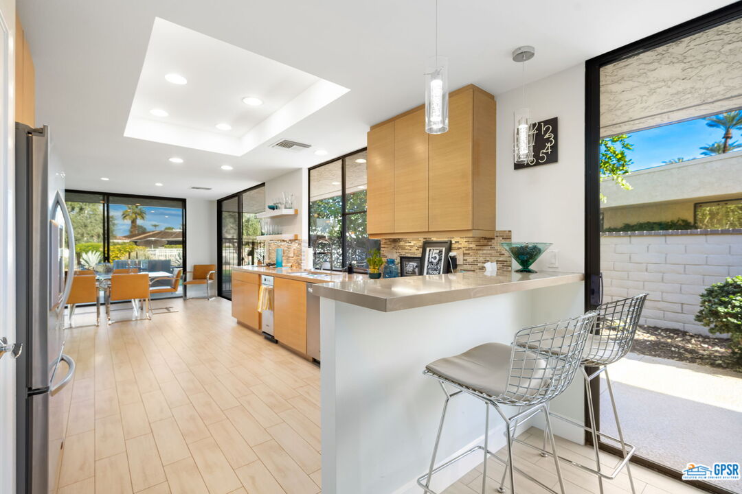 78 Colgate Drive Rancho Mirage, CA 92270 - Photo 15 of 56 a living room with stainless steel appliances kitchen island granite countertop furniture and a large window