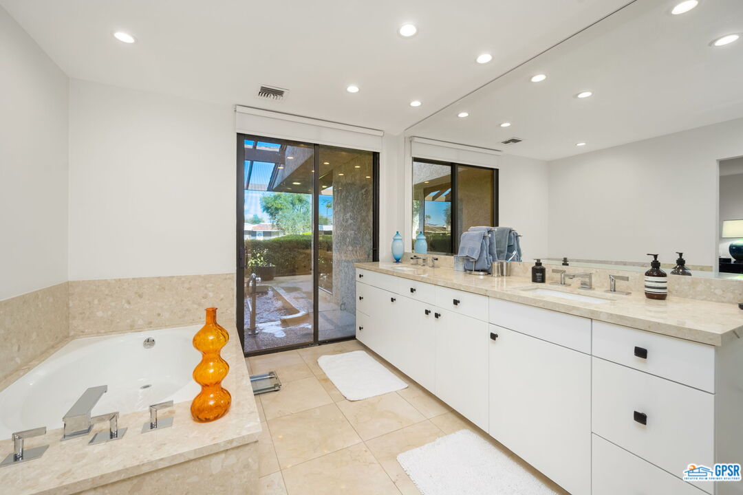 78 Colgate Drive Rancho Mirage, CA 92270 - Photo 24 of 56 a bathroom with a double vanity sink and mirror