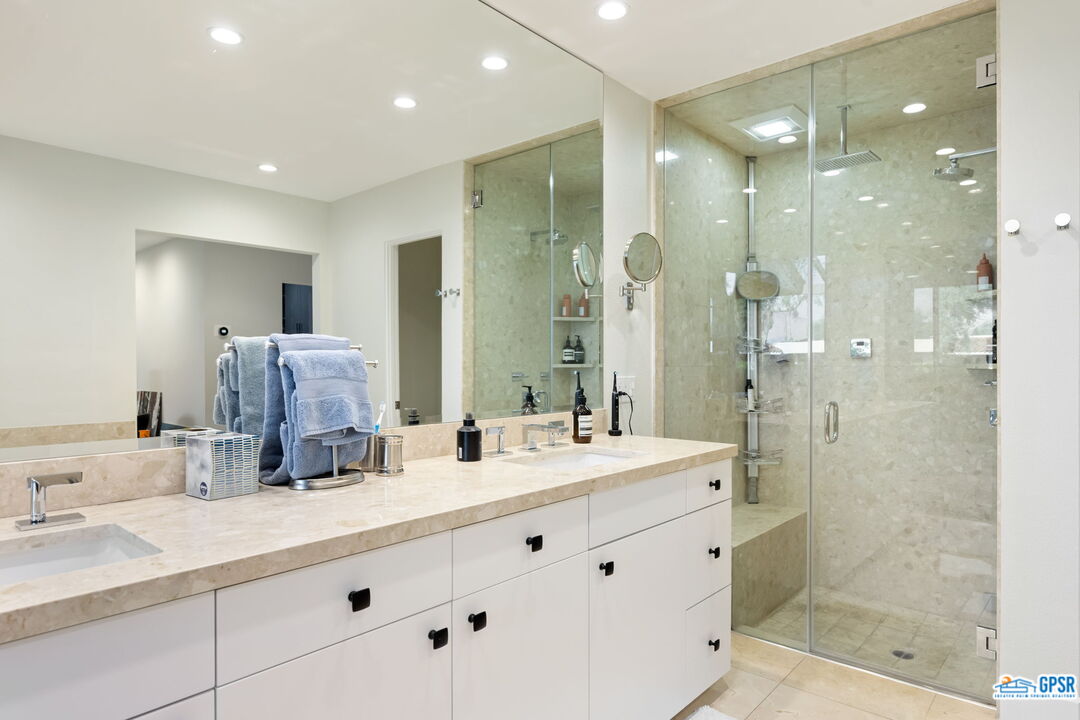78 Colgate Drive Rancho Mirage, CA 92270 - Photo 25 of 56 a bathroom with a double vanity sink mirror double shower and a
