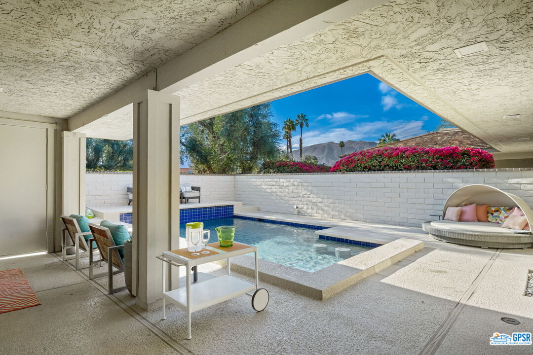 78 Colgate Drive Rancho Mirage, CA 92270 - Photo 33 of 56 a living room with furniture and a floor to ceiling window