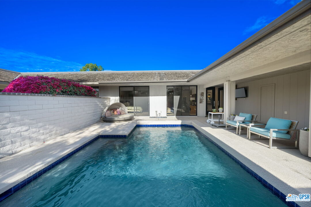 78 Colgate Drive Rancho Mirage, CA 92270 - Photo 39 of 56 a view of a patio with dining table and chairs under an umbrella