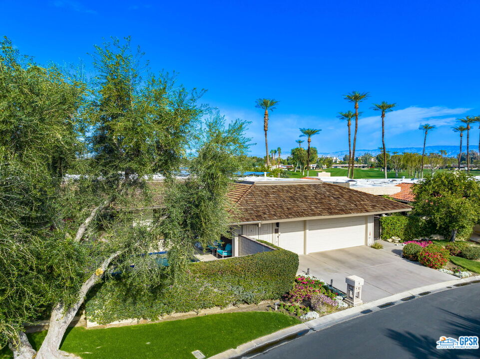 78 Colgate Drive Rancho Mirage, CA 92270 - Photo 50 of 56 a view of a house with a yard and potted plants